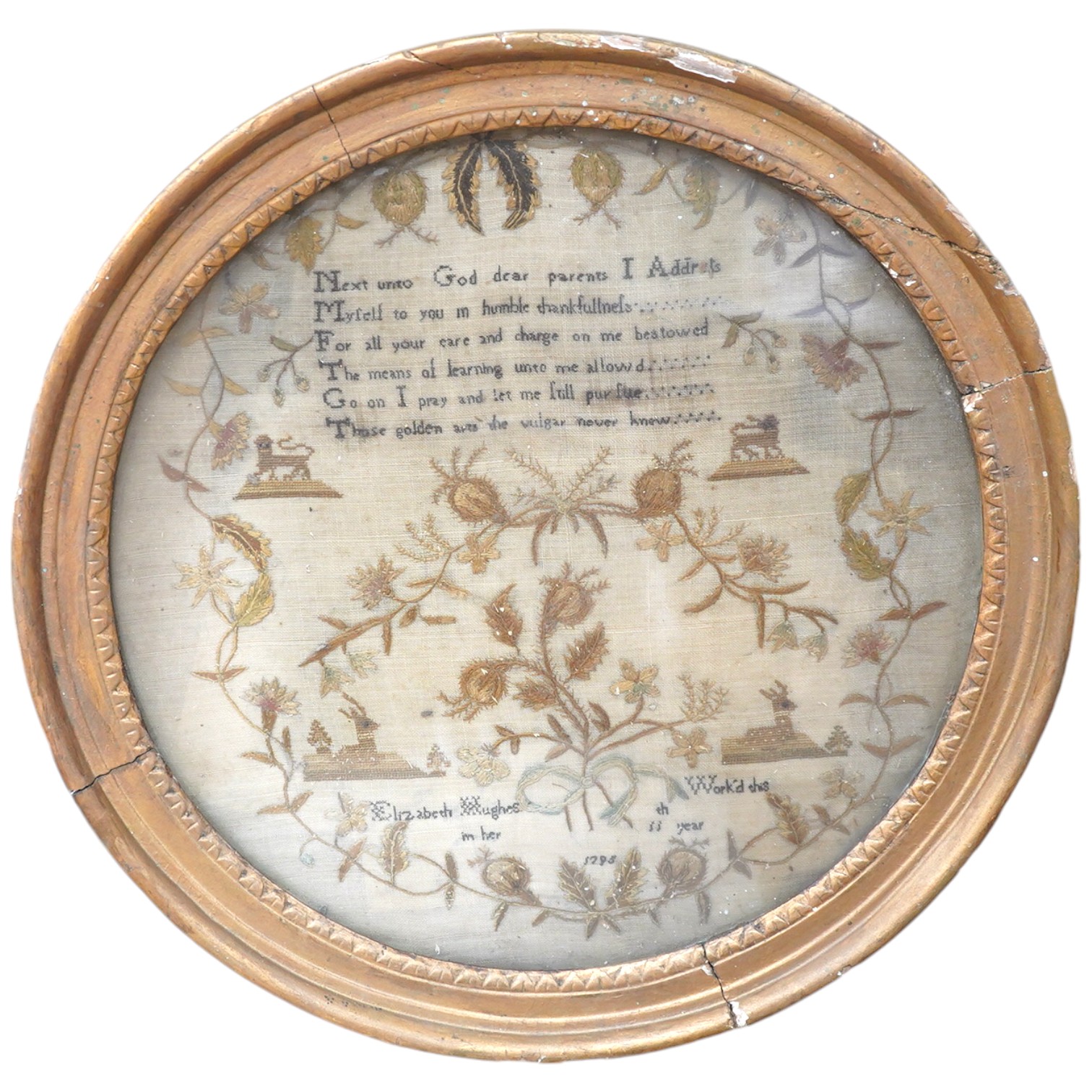 An unusual charming circular gilt framed sampler, by Elizabeth Hughes, aged 11 years, dated 1795, worked in fine wools with a prayer verse at the top and an embroidered floral border with motifs of lions, stags, flowers,